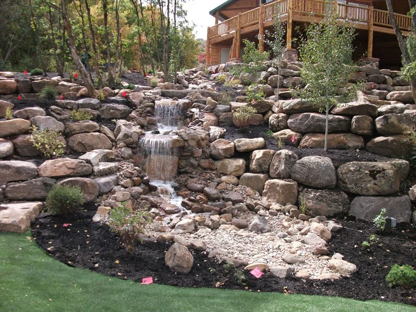 A & D Landscaping boulder retaining wall and water feature project in Cache Valley